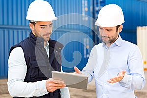 Engineer and worker speaking about work on the dock