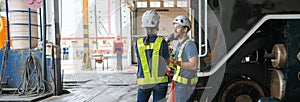 Engineer with worker talking together at factory