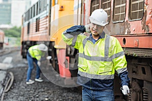 Engineer worker tired fatigue from hard working hot weather outdoor jobs with old diesel train male service staff