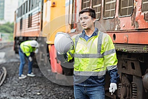 Engineer worker tired fatigue from hard working hot weather outdoor jobs with old diesel train male service staff