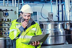 Engineer worker using Walkie Talkie radio calling order working in factory