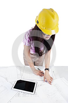 Engineer working with blueprints on desk