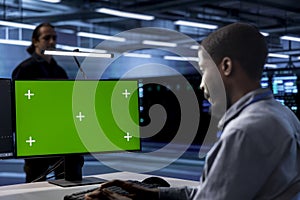Engineer working at chroma key PC to prevent damages in server farm
