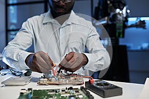 Engineer working with computer board in office