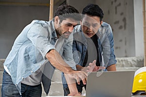 Engineer working at construction site meeting and discussing on laptop