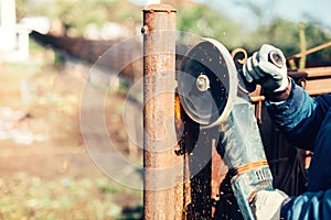 engineer working and cutting metal reinforced steel bars using angle grinder