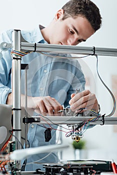 Engineer working on a 3D printer