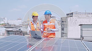 Engineer working and discussing a plan to install solar panels. Engineer working on checking equipment in solar power plant