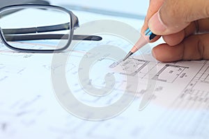 Engineer working on engineering drawing for a project.