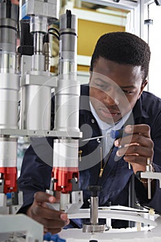 Engineer Working On Machine In Factory