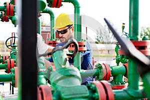 Engineer, working with pipeline controls inside oil and gas refinery