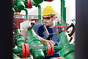 Engineer, working with pipeline controls inside oil and gas refinery