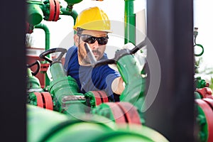 Engineer, working with pipeline controls inside oil and gas refinery