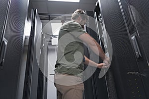 IT engineer working In the server room or data center The technician puts in a rack a new server of corporate business
