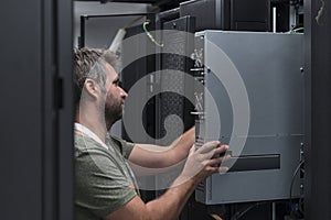 IT engineer working In the server room or data center The technician puts in a rack a new server of corporate business