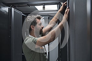 IT engineer working In the server room or data center The technician puts in a rack a new server of corporate business