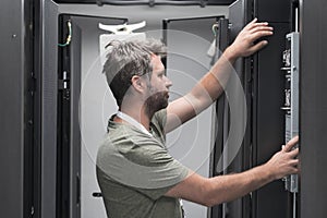 IT engineer working In the server room or data center The technician puts in a rack a new server of corporate business