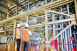 Engineer working in a thermal power plant with talking on radio