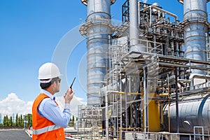 Engineer working at thermal power plant with talking on radio