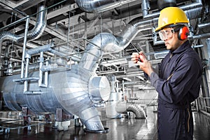 Engineer working in a thermal power plant with talking on radio