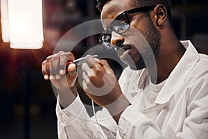 Engineer working with tongs and wires at the factory