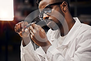 Engineer working with tongs and wires at the factory