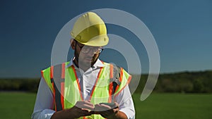 Engineer working using smartphone at the construction site. Checking of solar panels