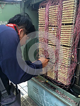 The engineer works with the telephone exchange equipment.