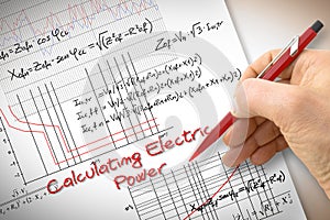 Engineer writing formulas and graph about electric power in buildings - concept image