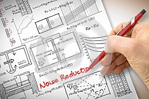 Engineer writing formulas about noise reduction in buildings - c