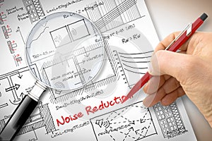Engineer writing formulas about noise reduction in buildings - Concept image seen through a magnifying glass