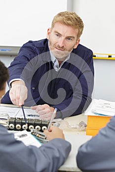 engineering apprentice presenting to group at whiteboard