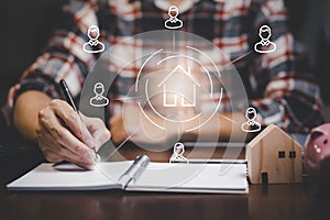 Engineering and architecture drawings and mini home model concept, Engineer man writing of architect starting draw a house