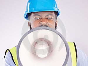 Engineering black man, megaphone and construction in studio portrait for angry shouting by white background. Engineer