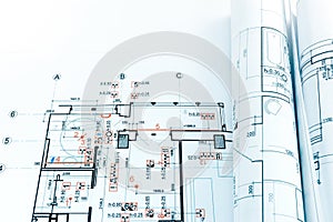 engineering blueprints and rolls of architectural project drawings