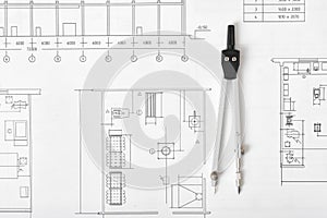 Engineering compass is on building plan.