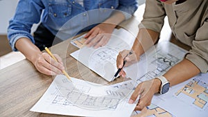 Engineering construction concept, Two female engineers is discussing blueprint of building together