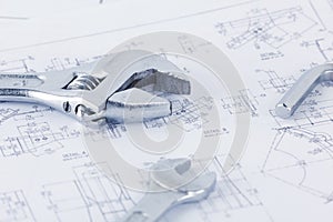 Engineering drawing documents with wrench. Maintencance concept