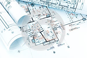 engineering electricity technical project with rolls of architectural blueprints