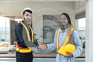 Engineering and foreman shaking hands on construction site and Agree. partnership and connection. Architect building supervising