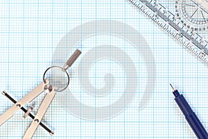 Engineering graph paper and compass still life