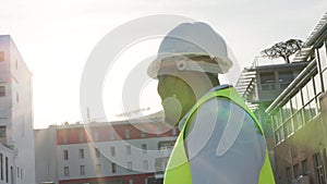 Engineering, helmet and man at outdoor construction site, building development and compliance or inspection. Gear