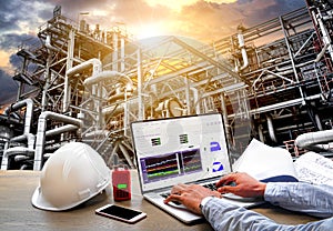 Engineering Industry concept in office with Oil and gas Industry,Refinery at sunset ,Pipelines and petrochemical plant background