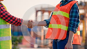 Engineering joins hand in business in industrial port background photo