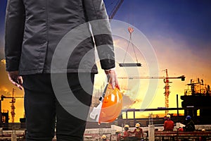 Engineering man holding safety helmet and working in building co