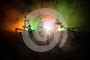 Engineering man standing against beautiful dusky sky of oil refinery plant. Silhouette of a man standing on the road at the