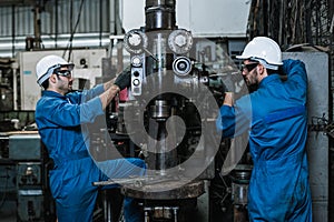 Engineering man wearing uniform safety workers perform maintenance in factory working machine lathe metal