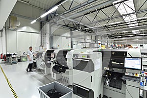 engineering in microelectronics: workers in the production and assembly of electronic high tech components in a modern factory photo