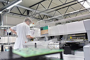 engineering in microelectronics: workers in the production and assembly of electronic high tech components in a modern factory photo