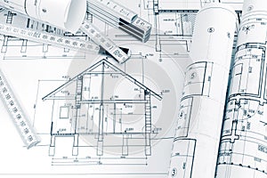 engineering plans of house renovation and folding ruler on architects workspace